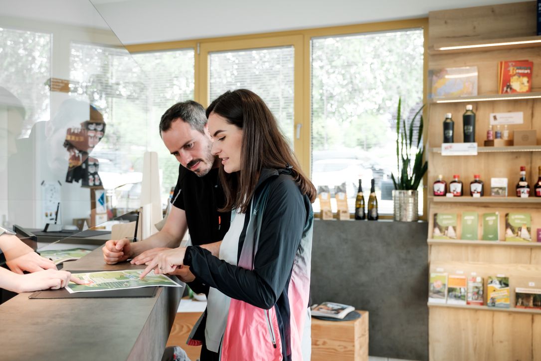 Two people receiving advice at a tourist office