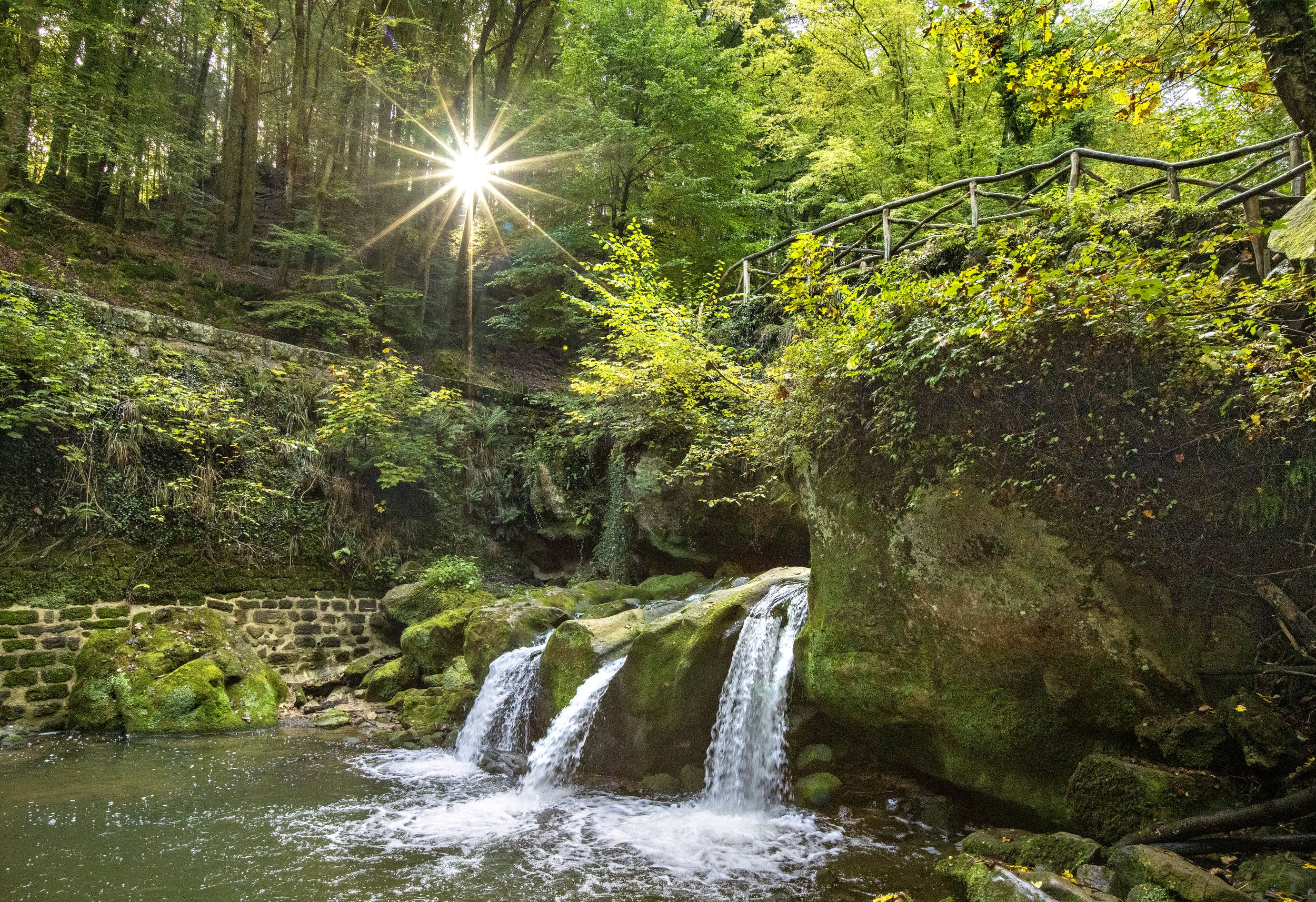 Schéissendëmpel waterfall with bridge in Mullerthal Region