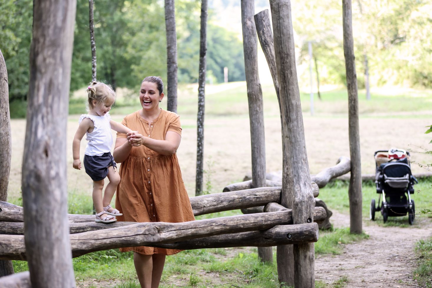 A mother playing with her child on a playground