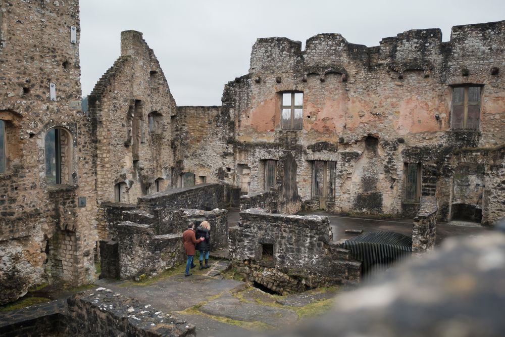 Visitors exploring the ruins of Larochette Castle