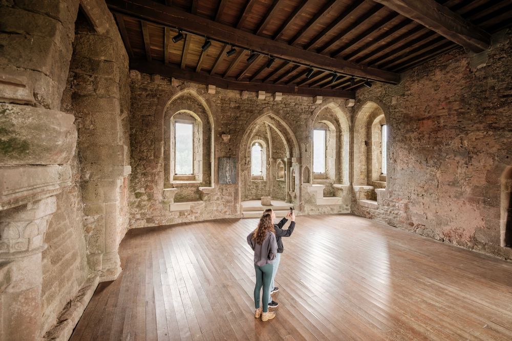 Visitors taking a photo inside Larochette Castle