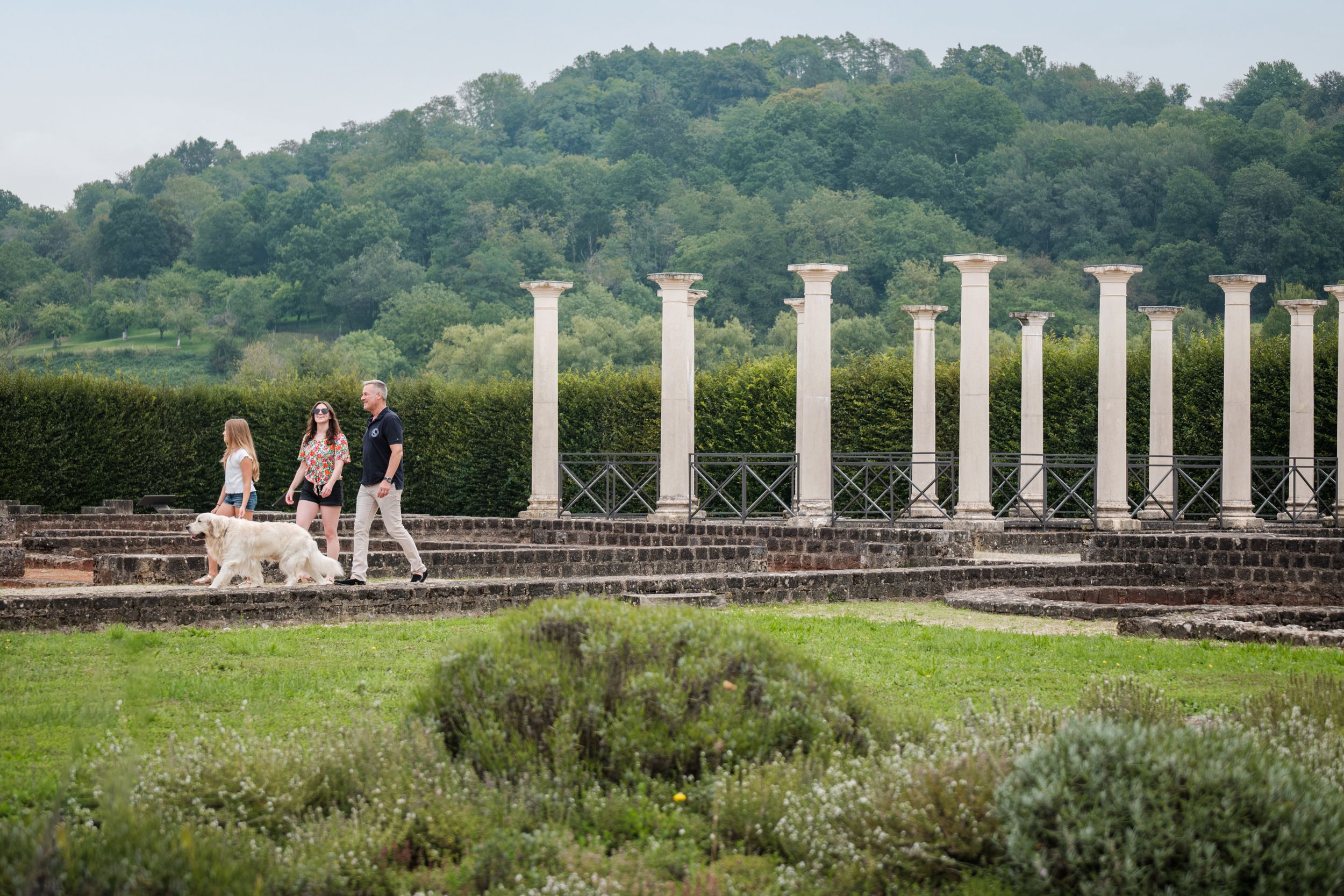 A family with a dog visiting the grounds of the Gallo-Roman Villa in Echternach