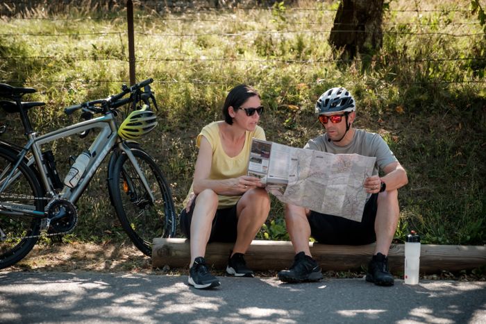 Twee fietsers nemen een pauze en kijken op de kaart