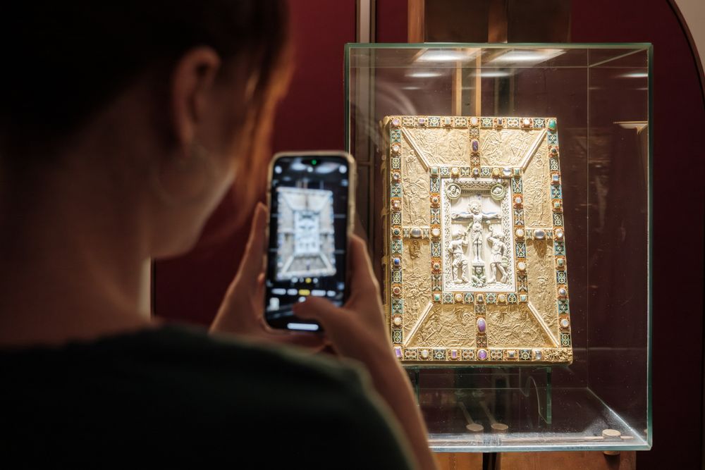 A visitor taking a picture in the abbey museum in Echternach