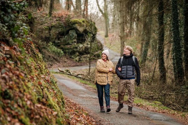 Deux randonneurs sur le Mullerthal Trail Route 2 à Scheidgen près du « Härgottskapp ».